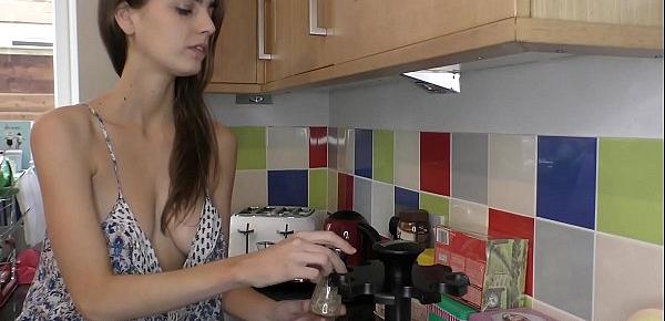 Sexy busty brunette smelling the spices in the kitchen